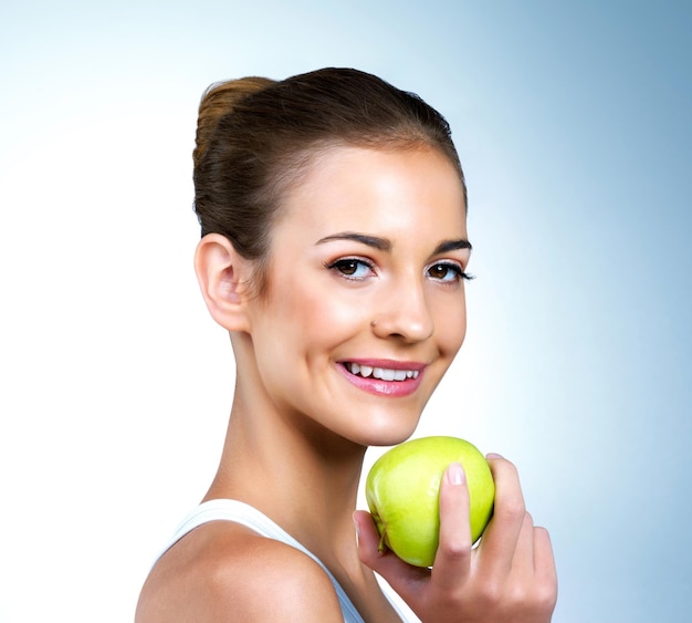 Its the secret to my healthy glow Portrait of a healthconscious young woman posing with an apple in studio