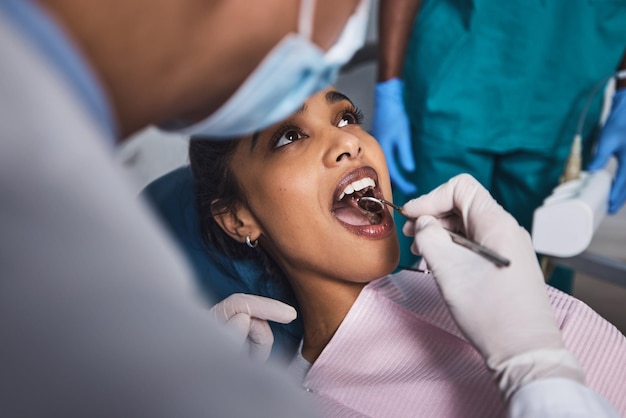 Photo its time to start smiling again shot of a young woman having dental work done on her teeth