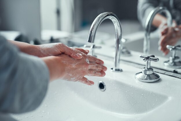 Its vital to practice good personal hygiene Closeup shot of an unrecognizable woman washing her hands in the bathroom at home