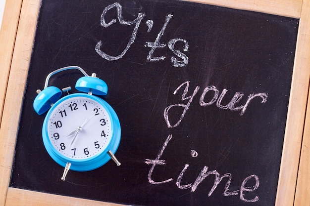 Its your time words written on chalkboard blue retro alarm clock