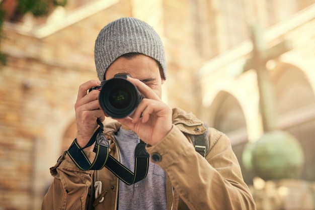 Ive found the perfect shot portrait of a young man taking photos on his camera outside