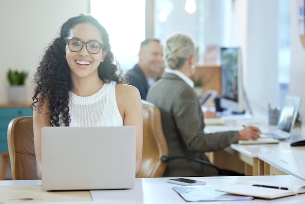 Ive got everything I need right here Shot of a young businesswoman using a laptop in an office at work