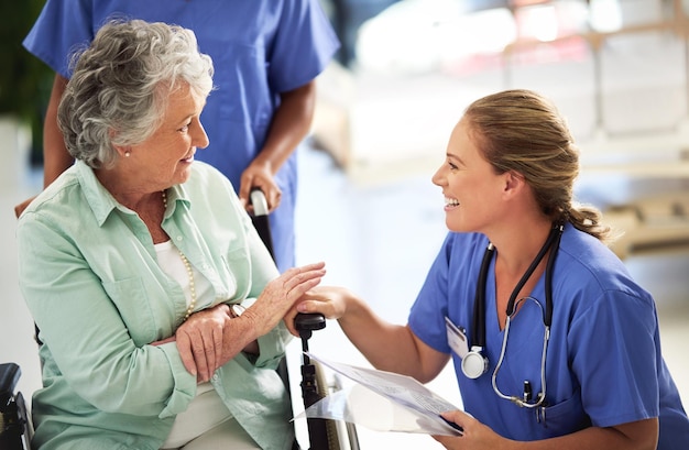 Photo ive got some good news for you shot of a doctor discussing treatments with a senior woman sitting in wheelchair in a hospital