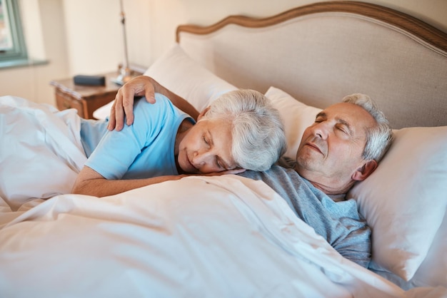 Ive listened to this heartbeat for years Cropped shot of an affectionate senior couple cuddling each other while asleep in bed at a nursing home