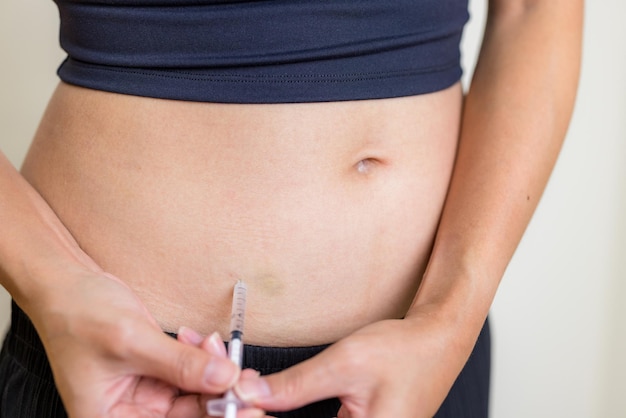 Photo ivf and infertility treatment concept woman have injection on her belly