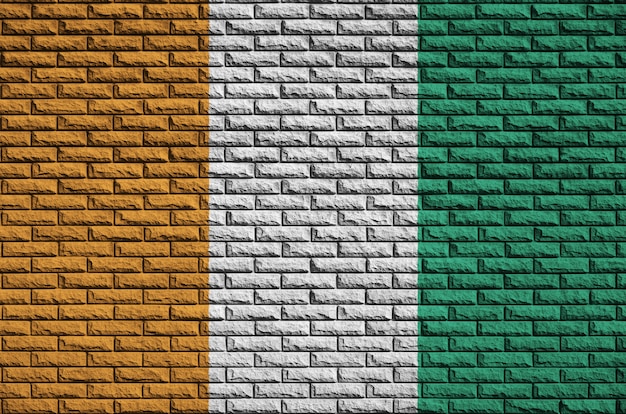 Ivory Coast flag is painted onto an old brick wall