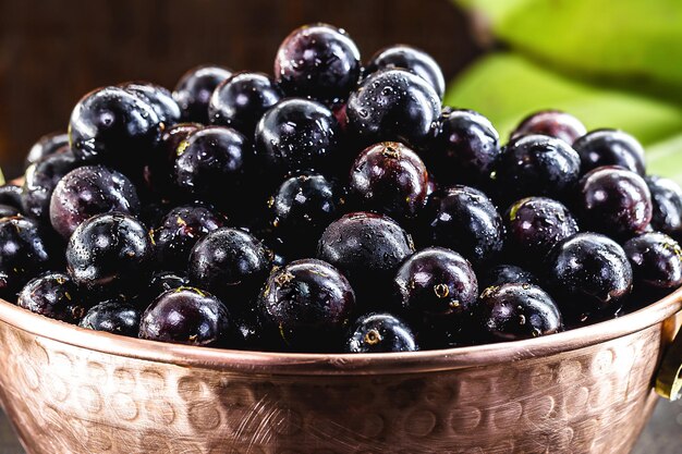 Jabuticaba Brazilian and South American tropical fruits in a copper pot on a rustic table