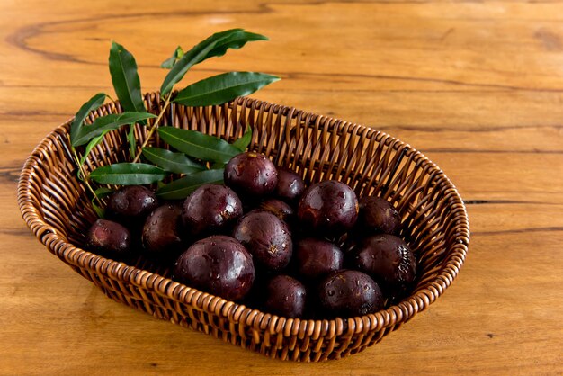 Jabuticaba, exotic Brazilian fruits on wooden table, Jaboticaba is a common fruit in South America