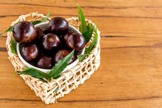 Jabuticaba, exotic Brazilian fruits on wooden table, Jaboticaba is a common fruit in South America