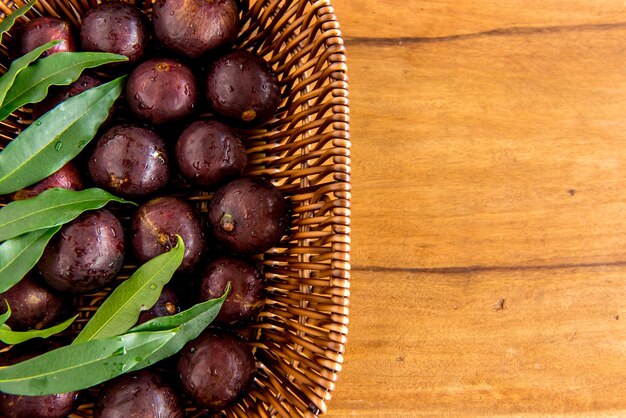 Jabuticaba, exotic Brazilian fruits on wooden table, Jaboticaba is a common fruit in South America