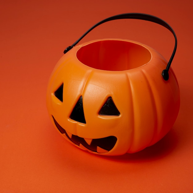 Jack o lantern pumpkin on an orange background