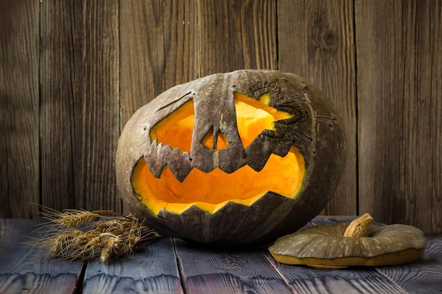 Jack o lanterns Halloween pumpkin face on wooden background