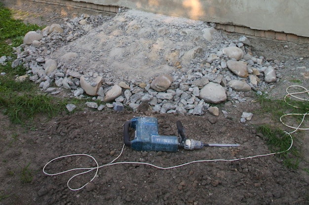 Jackhammer and broken concrete and stones