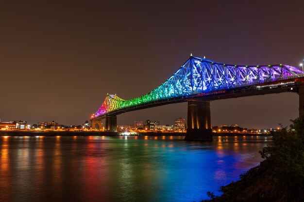 Jacques Cartier Bridge in a rainbow lighting at night Montreal Quebec Canada