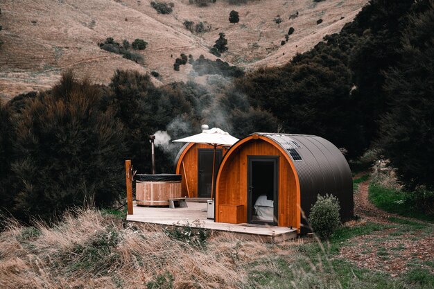 Photo jacuzzi cabins and solitary smoking fireplace to relax and sleep in the middle of nature with all