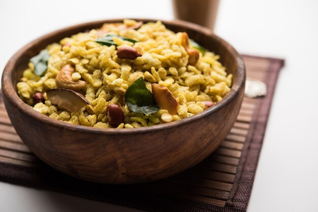 Jada Poha Namkeen Chivda or Thick Pohe Chiwda is a jar snack with a mix of sweet, salty and nuts flavours, served with tea. selective focus