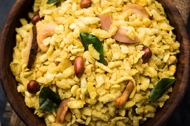 Jada Poha Namkeen Chivda or Thick Pohe Chiwda is a jar snack with a mix of sweet, salty and nuts flavours, served with tea. selective focus