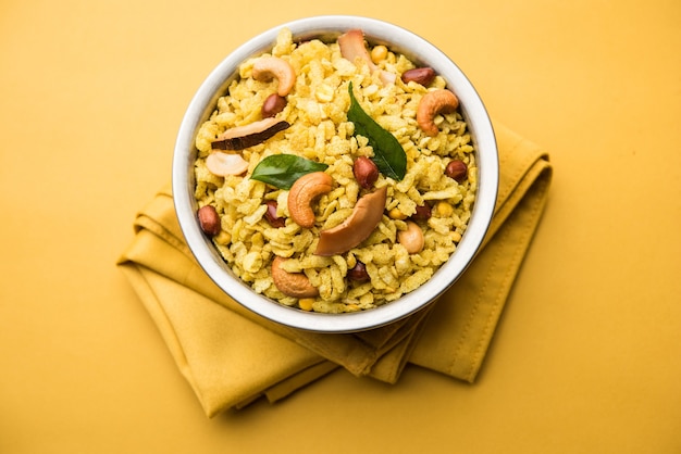 Jada Poha Namkeen Chivda or Thick Pohe Chiwda is a jar snack with a mix of sweet, salty and nuts flavours, served with tea. selective focus