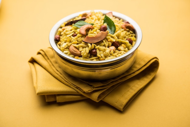 Jada Poha Namkeen Chivda or Thick Pohe Chiwda is a jar snack with a mix of sweet, salty and nuts flavours, served with tea. selective focus