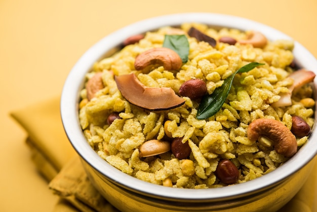 Jada Poha Namkeen Chivda or Thick Pohe Chiwda is a jar snack with a mix of sweet, salty and nuts flavours, served with tea. selective focus