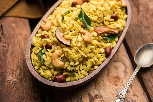 Jada Poha Namkeen Chivda or Thick Pohe Chiwda is a jar snack with a mix of sweet, salty and nuts flavours, served with tea. selective focus