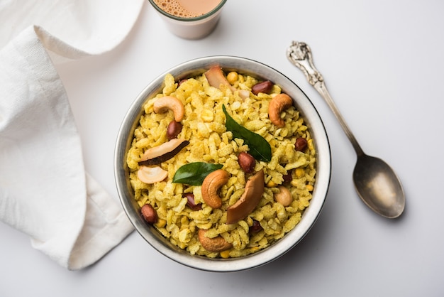 Jada Poha Namkeen Chivda or Thick Pohe Chiwda is a jar snack with a mix of sweet, salty and nuts flavours, served with tea. selective focus