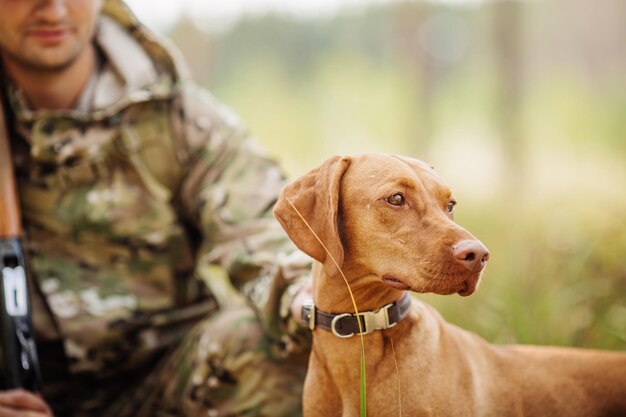 Jager met een hond in het bos