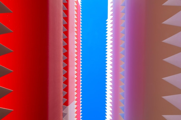 Jagged edges of folded wind turbine blades against a blue background bottom view