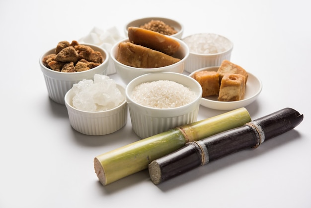 Jaggery, Sugar Variety and Sugarcane - by-products of Sugar Cane or Ganna placed over moody background. Selective focus