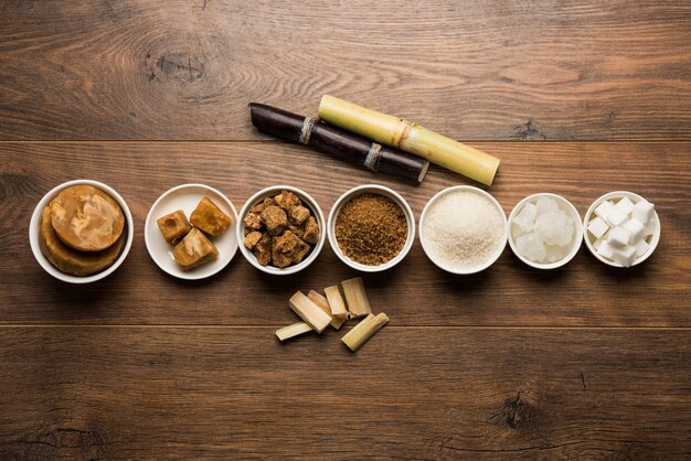 Jaggery, Sugar Variety and Sugarcane - by-products of Sugar Cane or Ganna placed over moody background. Selective focus