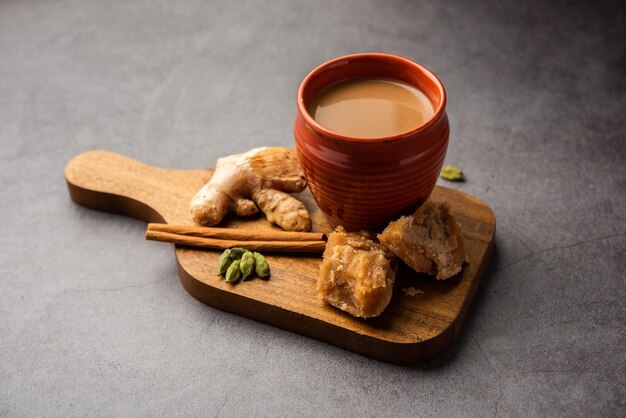 Jaggery tea or Gur ki chai with ingredients like gud ginger or adrak green cardamom and cinnamon