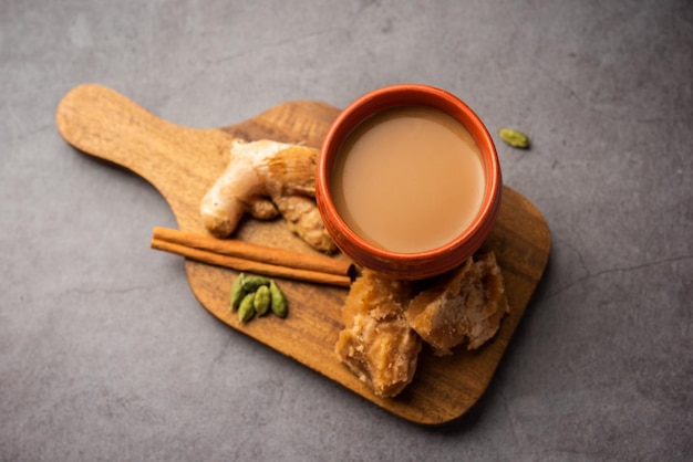 Jaggery tea or Gur ki chai with ingredients like gud ginger or adrak green cardamom and cinnamon