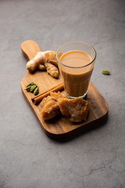 Jaggery tea or Gur ki chai with ingredients like gud ginger or adrak green cardamom and cinnamon