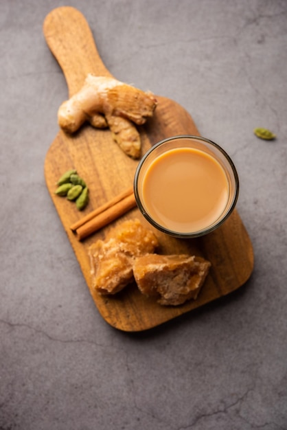 Jaggery tea or Gur ki chai with ingredients like gud ginger or adrak green cardamom and cinnamon