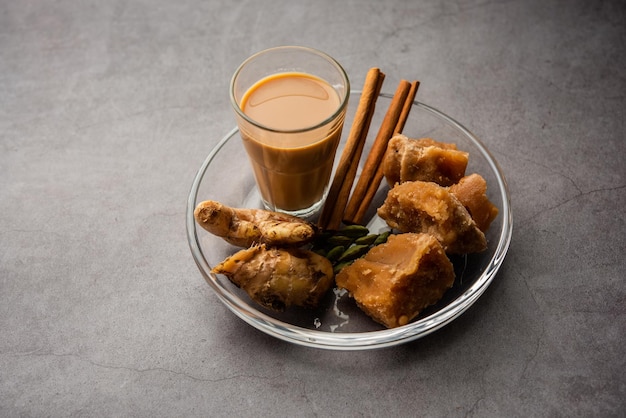 Jaggery tea or Gur ki chai with ingredients like gud ginger or adrak green cardamom and cinnamon