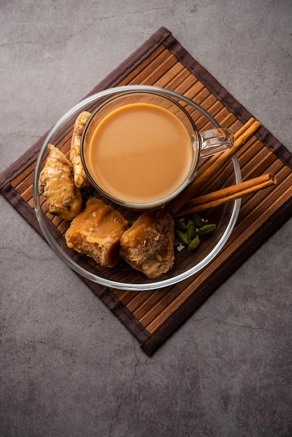 Jaggery tea or Gur ki chai with ingredients like gud ginger or adrak green cardamom and cinnamon