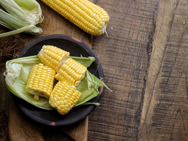 Jagung Manis Segar of verse zoete maïskolven op rustieke houten tafel