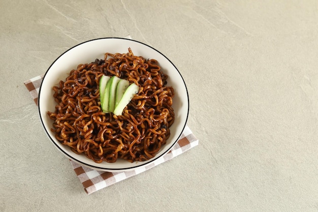 Jajangmyeon or JJajangmyeon is Korean Noodle with Black Sauce and cucumber.