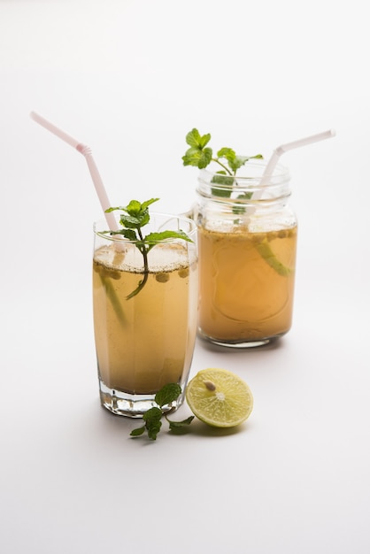 Jal-Jeera OR Jaljira is an Indian beverage prepared using mixing cumin powder in water and served cold with Boondi, Mint and Lemon slice. Served over moody background. Selective focus