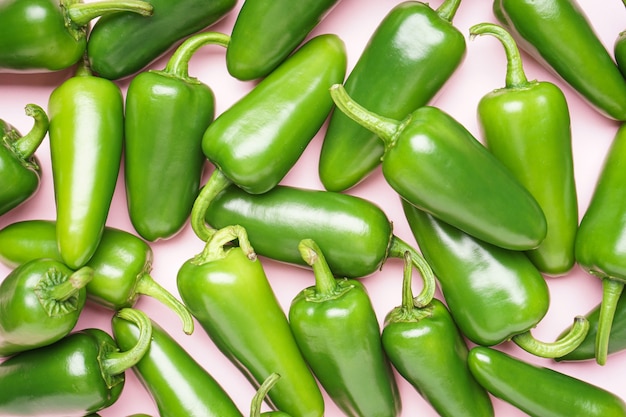 Jalapeno chili peppers, on a pink background, top view. Close-up.