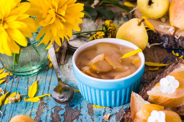 Jam from pears in a bowl on a wooden table