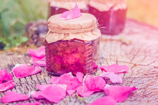 Photo jam from rose with rose petals on stump