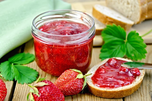 Jam strawberry with bread on the board