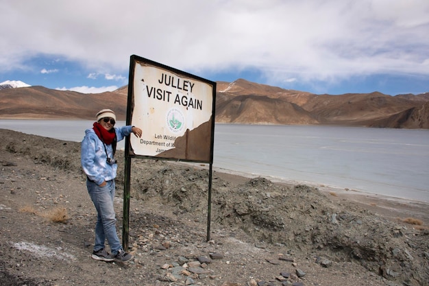 JAMMU KASHMIR INDIA MARCH 20 Traveler thai woman travel visit for take photo with Himalaya mountain and Pangong Tso high grassland lake at Leh Ladakh on March 20 2019 in Jammu and Kashmir India