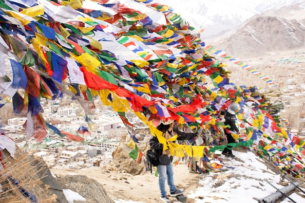 JAMMU KASHMIR INDIA MARCH 20 Traveler thai women tied prayer and blessing flags on mount of Thiksey monastery and Namgyal Tsemo Gompa in Leh ladakh on March 20 2019 in Jammu and Kashmir India