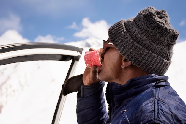 JAMMU KASHMIR INDIA MARCH 21 Indian or tibetan driver rest and drinking hot tea top of mountain on Khardung La Road go to nubra valley at Leh Ladakh on March 21 2019 in Jammu and Kashmir India