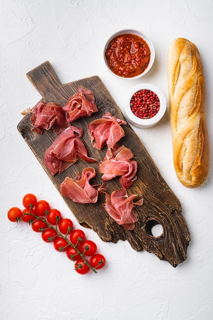 Jamon serrano Traditional Spanish ham set on white stone table background top view flat lay