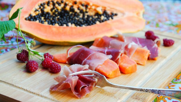 Jamon with papaya and raspberries