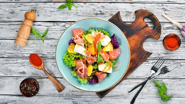 Jamonsalade met brie en sinaasappelkaas Op het bord Rustiek Bovenaanzicht Vrije ruimte voor uw tekst