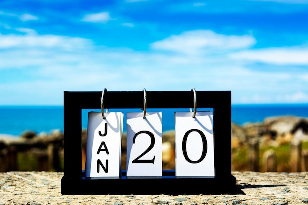 Photo jan 20 calendar date text on wooden frame with blurred background of ocean calendar concept